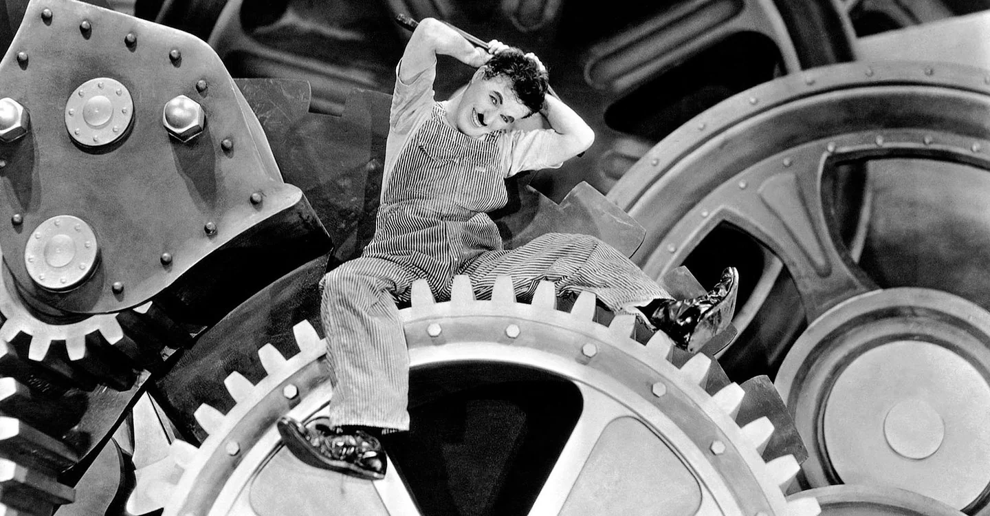 Charlie Chaplin in Modern Times (1936) wearing Stronghold hickory striped bib-overalls