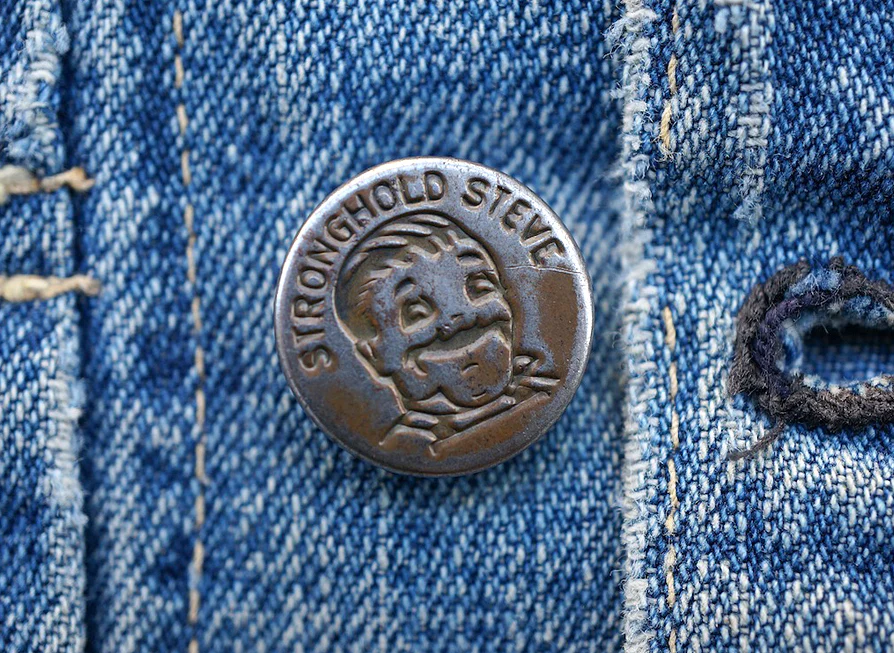 Stronghold Steve metal button on a denim garment
